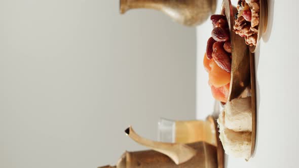 Vertical Video of Turkish Tea and Sweets Hot Drink in Traditional Armudu Glass Closeup