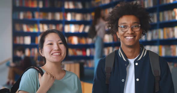 Portrait of Happy Diverse College Students Smiling at Camera in Library