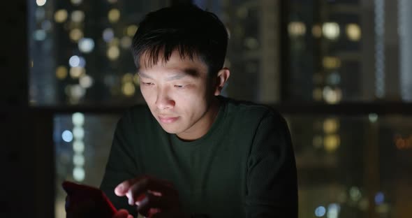 Man use of mobile phone at night