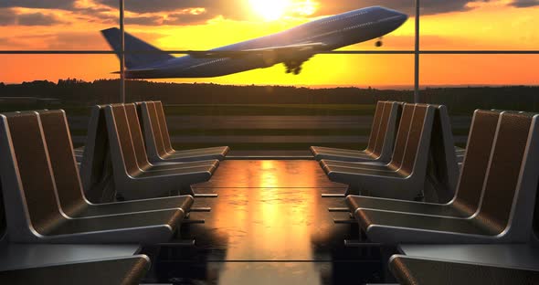 Airplane Take-Off against Scenic Sunset seen through Departure Lounge Windows alt