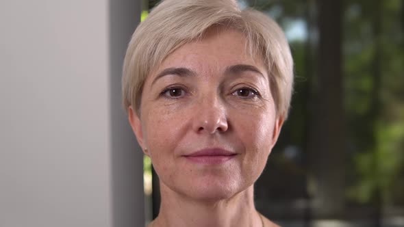 European Aged Smiling Blonde Woman with Brown Eyes Close Up Portrait