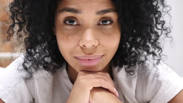 Close Up of Serious Young AfroAmerican Woman Face in Bed