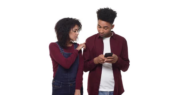  Young African American Couple Playing with Their Phones While on a Date.