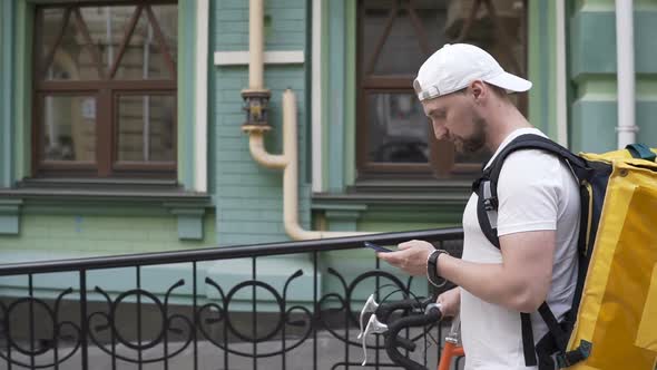 Delivery Man Courier Arrives at Residential Address To Deliver Food