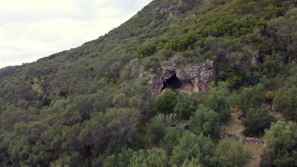 1 million $ long aerial view flight drone footage out of aa big explorer cave in a mountain in the w