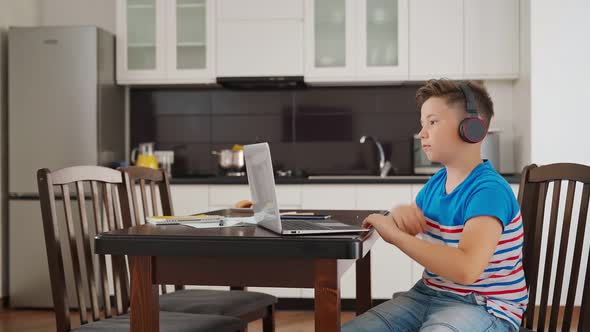 Boy Using Laptop While Staying at Home During Distance Learning