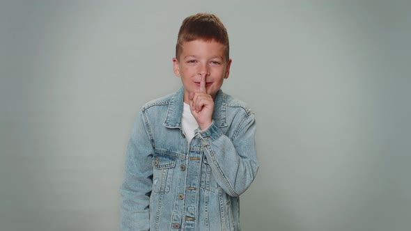 Boy Child Presses Index Finger to Lips Makes Silence Gesture Sign Do Not Tells Secret Shh Be Quiet