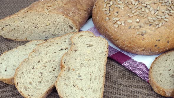 Fresh bread on table. Baked dark bread and sliced bread.