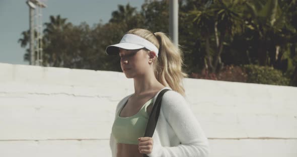 Young Tennis Player Walking On To Court