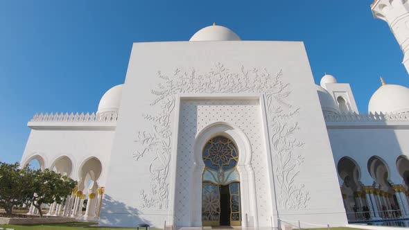 Sheikh Zayed Grand Mosque in Abu Dhabi showing its entrance gate and the beautiful gallery