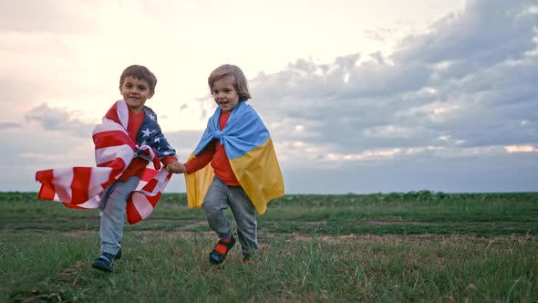 Ukrainian and American Boys Patriot Children Running Together with National Flags on Open Area Field