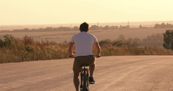 Man Riding Bike on the Countryside Road