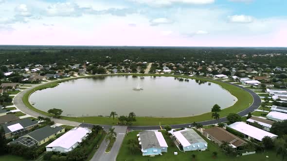 Aerial view of mobile home park with big round lake