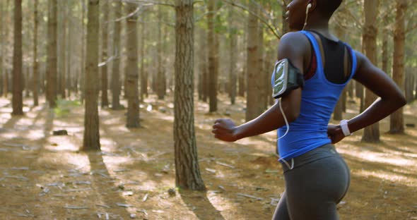 Woman jogging in the forest 4k