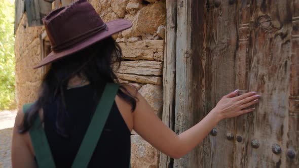 Woman in Front of Historical Door