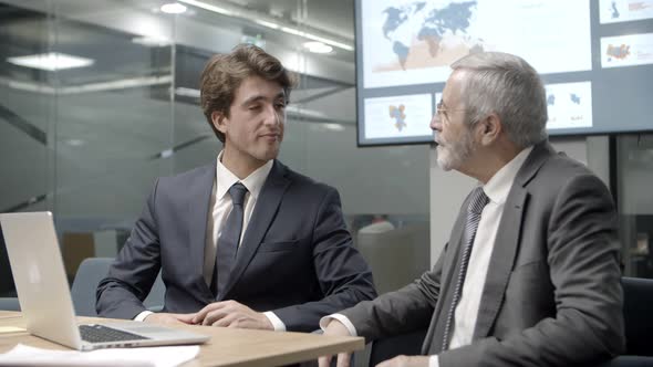 Confident Businessmen Communicating During Meeting