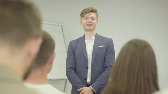 Portrait Handsome Confident Businessman Presenting New Project To Partners with Flip Chart