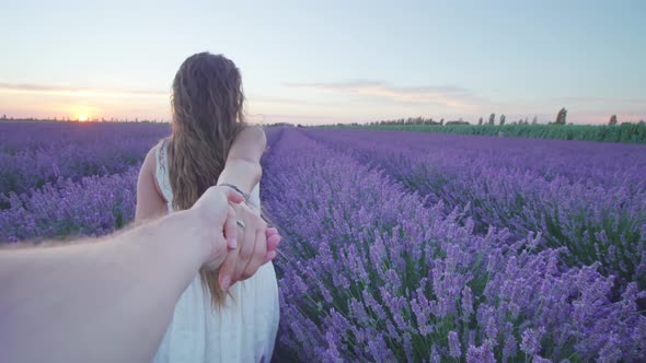 Girl Walks Among Lavender Holding Boy By the Hand