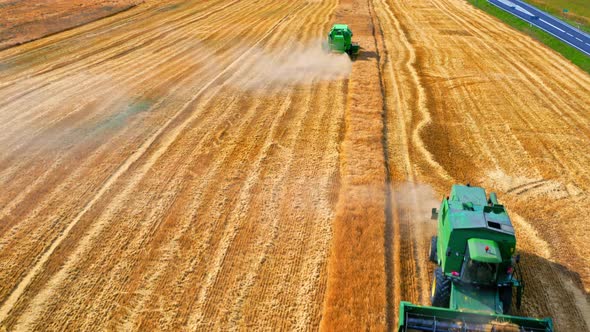 Aerial view of two harvesters harvesting seed on field