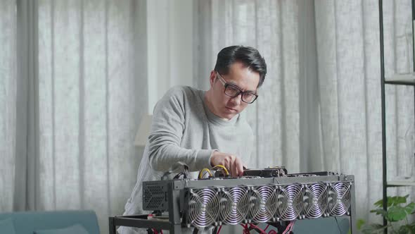 Asian Man Wearing Glasses Build The Mining Rig For Mining Cryptocurrency