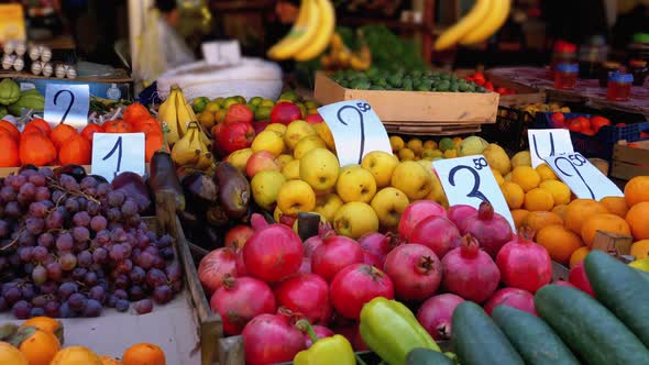 Showcase with Various Fruits, Persimmons, Pomegranate, Tangerines, Pears and More in the Street