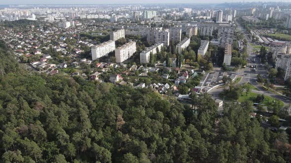 Megalopolis Next To the Forest: the Contact Between the Big City and Nature. Aerial View. Slow