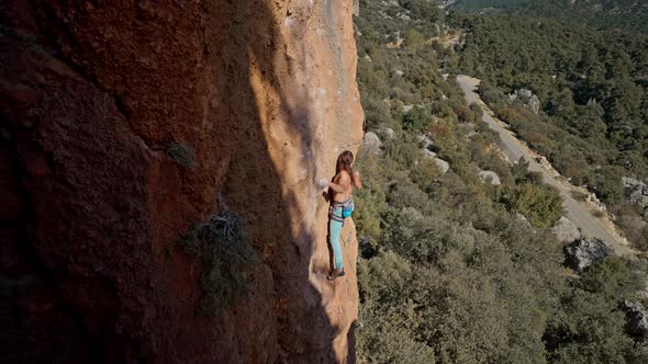 Top Side View Strong Fit Man Rock Climbing the Side of a Mountain