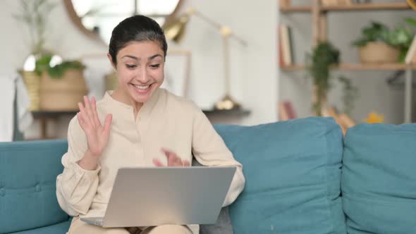 Online Video Call on Laptop By Indian Woman on Sofa