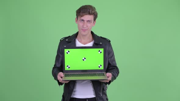 Stressed Young Rebellious Man Showing Laptop