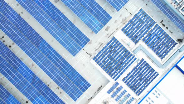 Aerial cinematic view of a solar panel on mall roof top