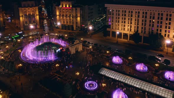 Top View of Fountains and Walking People in Holiday Night