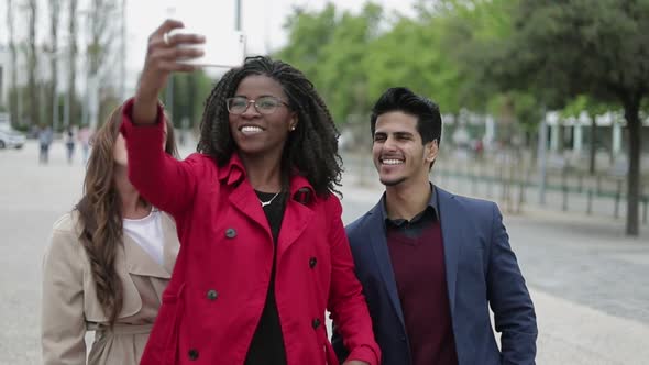 Women and Man Making Selfie Outside, Posing, Smiling