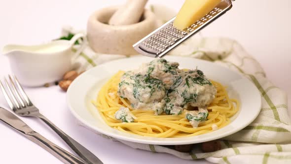 Portion of Delicious Meatballs with Spinach in a Creamy Sauce