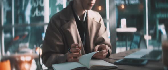 Business woman making notes in her notebook