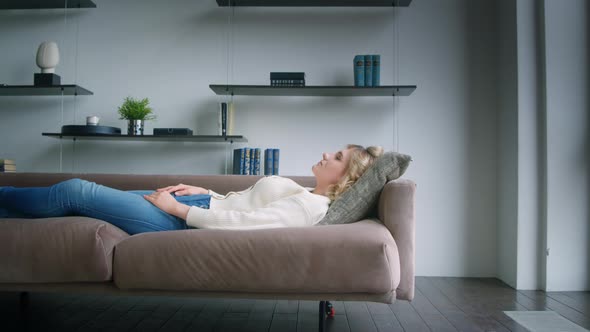 Young patient meditating on a couch in a psychotherapist's office