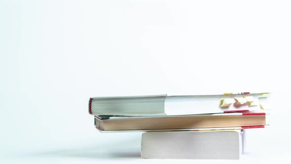 Stop Motion of a Stack of Old Books on a White Background