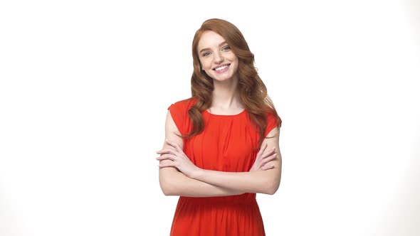 Lifestyle Concept: Smiling Mystery Ginger Woman in Orange Gorgeous Dress Holding Crossed Arms and