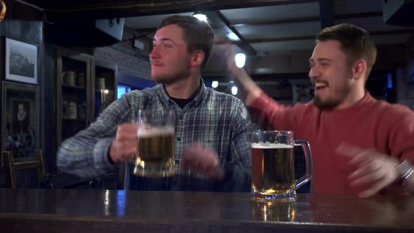 Friends Celebrate Success of Their Team at the Pub