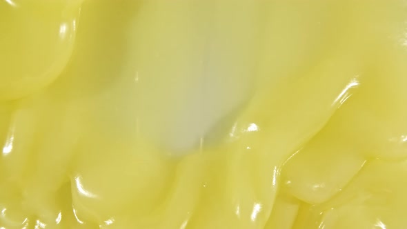 Yellow Cosmetic Gel Fluid Flowing Down on Surface