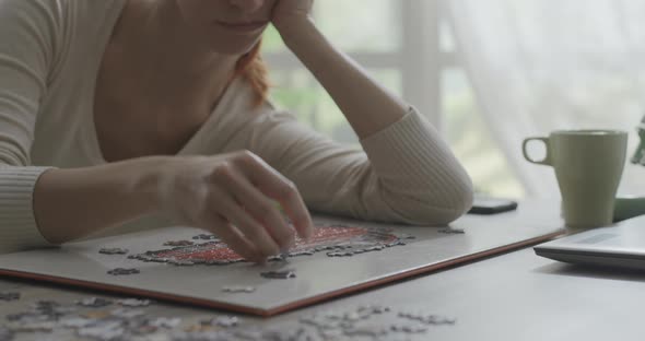 Bored woman composing a puzzle