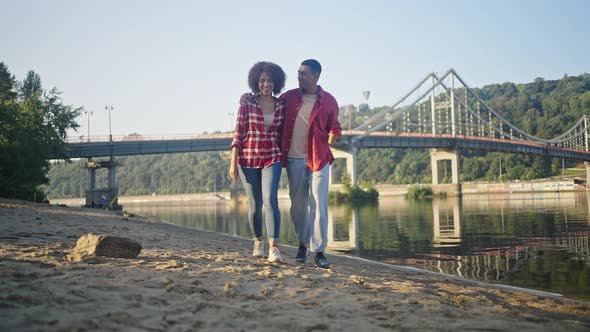 Young Boyfriend Tells Jokes to Lover Throwing Trash on Beach