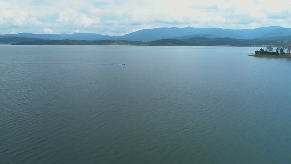 Small Sailing Boat in The Middle of Clear Water Lake in Bulgaria