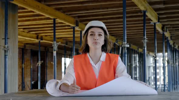 Architect working, browsing building project indoor of construction site with blueprint plan