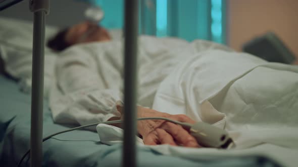 Patient Hand Moving Finger in Hospital Bed Closeup