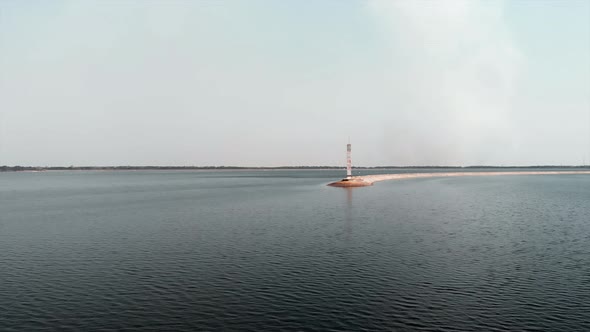 Aerial View of Lighthouse Surrounded by Seawater