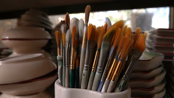 Painting Brushes In Ceramic Workshop alt