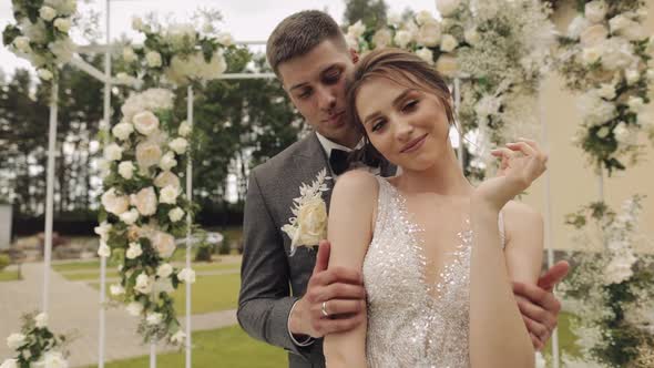 Newlyweds Caucasian Groom with Bride Walking Embracing Hugs in Park Wedding Couple