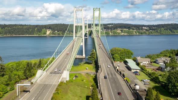 Clouds boil above the Tacoma Narrows Bridge, Puget Sound, aerial hyperlapse dolly zoom