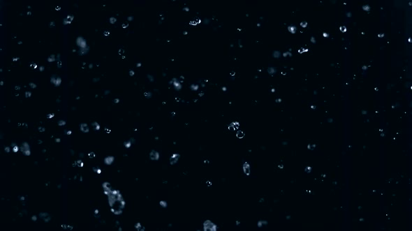 Slow-motion rain size droplets against black drop shooting with high speed camera, phantom flex.