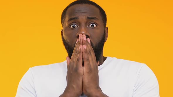 Impressed African-American Man Closing Mouth With Hands, Unbelievable Gossip